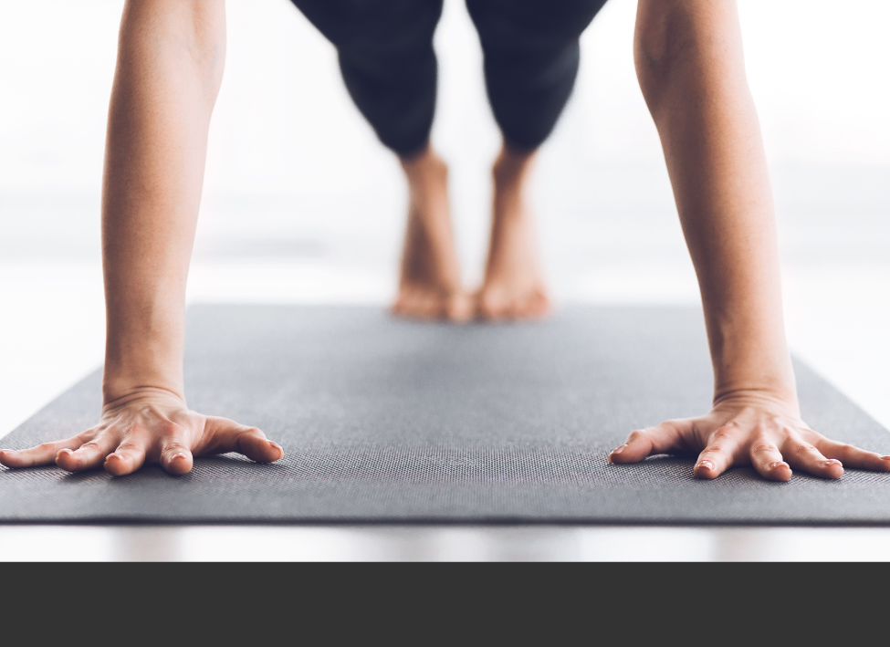 a pilates' pracitioner's arms in plank pose